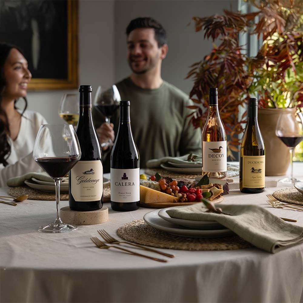 Red wines in a kitchen with fall foliage